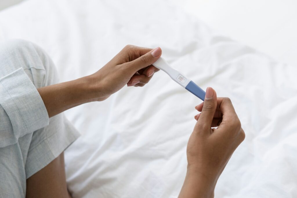 woman holding a positive pregnancy test